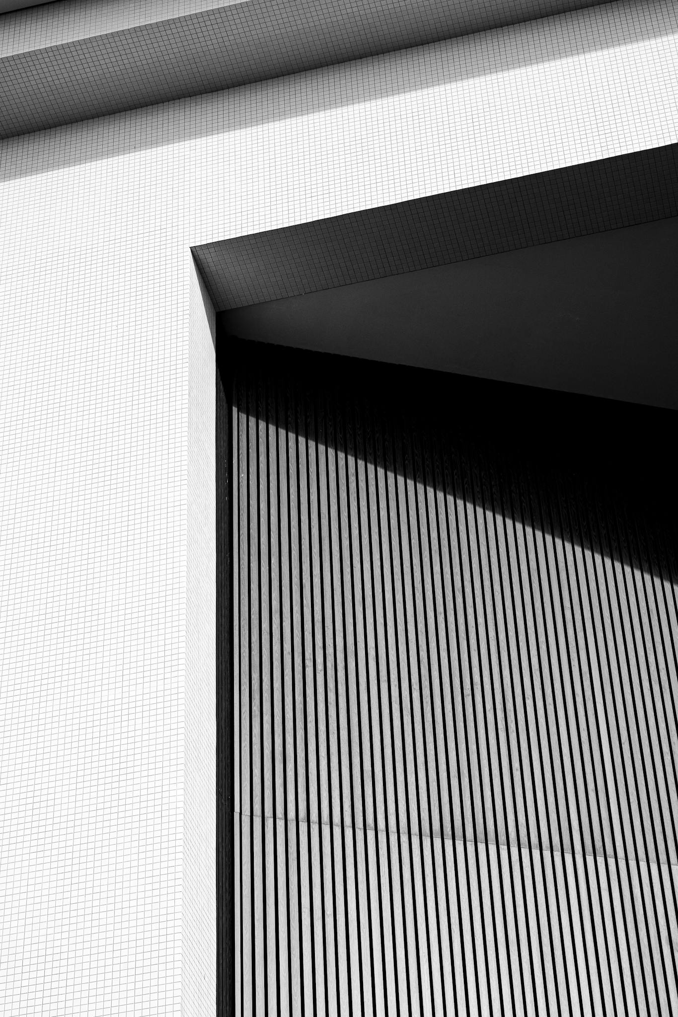Angular building facade with contrasting shadows representing Nomad Common's creative intelligence approach